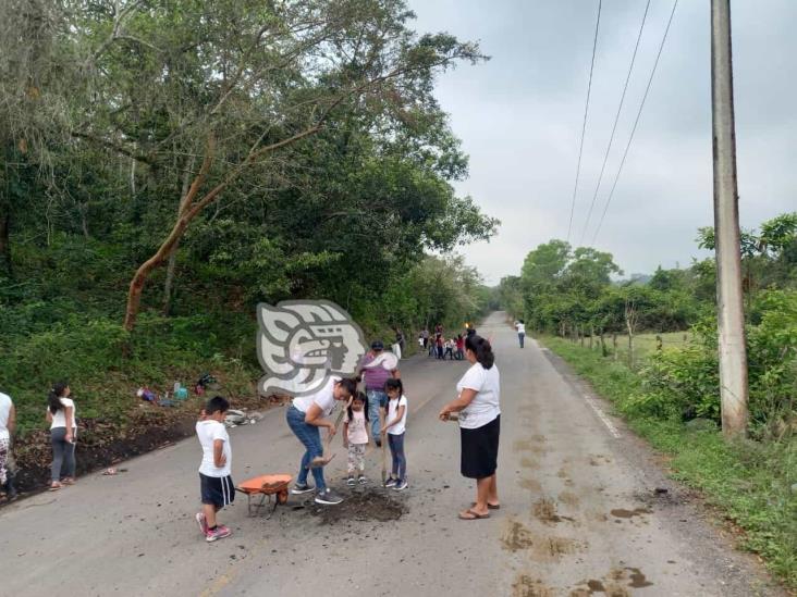 Padres de familia de kínder tapan baches de la carretera Misantla-El Diamante