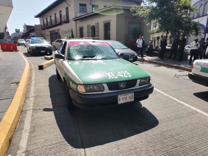 Estructura metálica cae sobre taxi en Xalapa